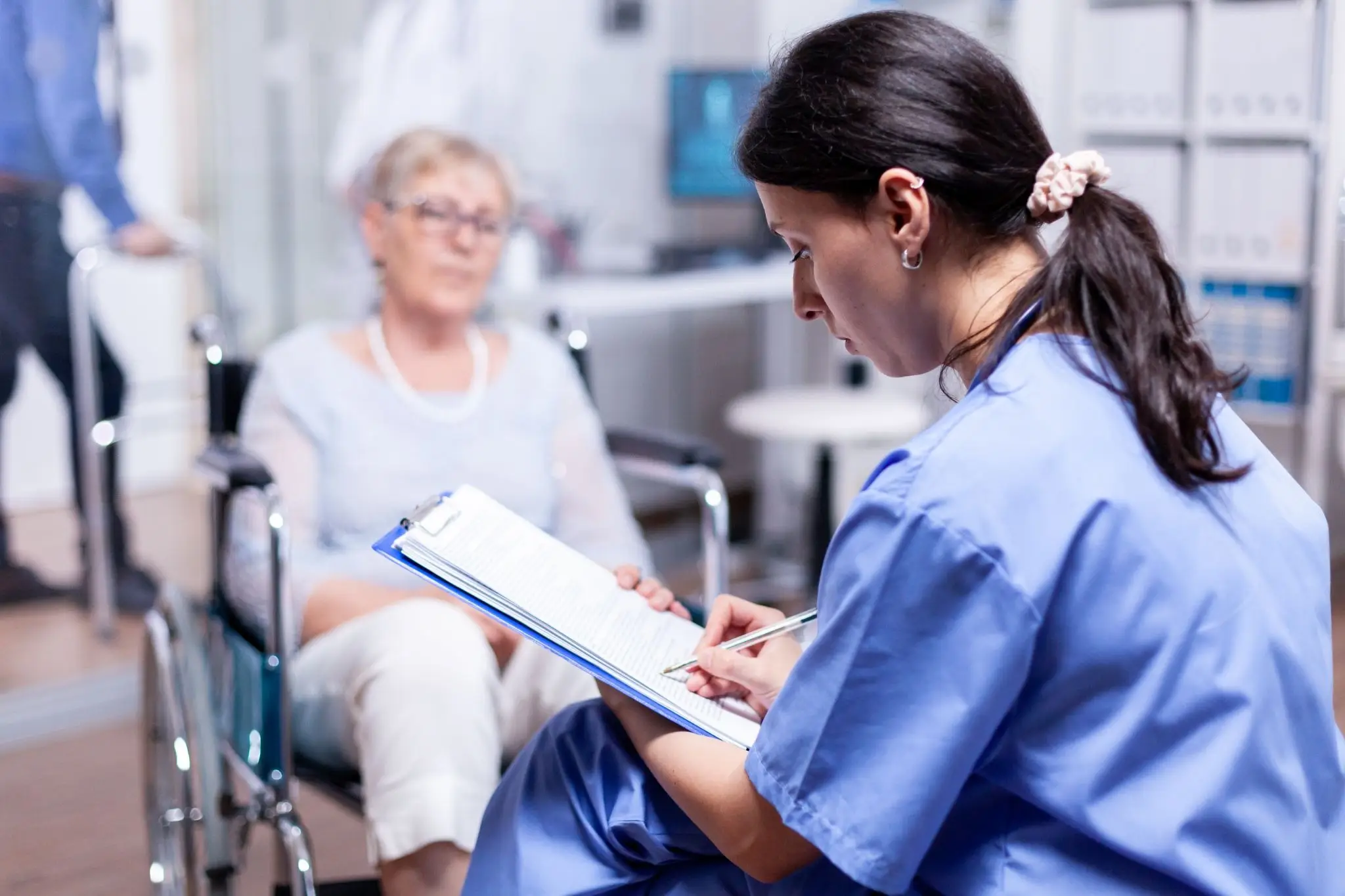 Certified nursing assistant providing patient care in a healthcare facility